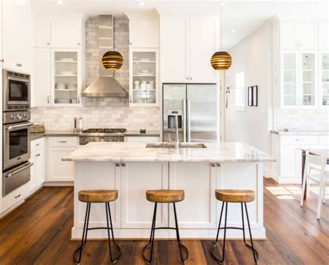 The natural blonde wood of this floor accents the white cabinet, while contrasting the bright warm wood of the island. 3 White and Wood Kitchens to Learn From