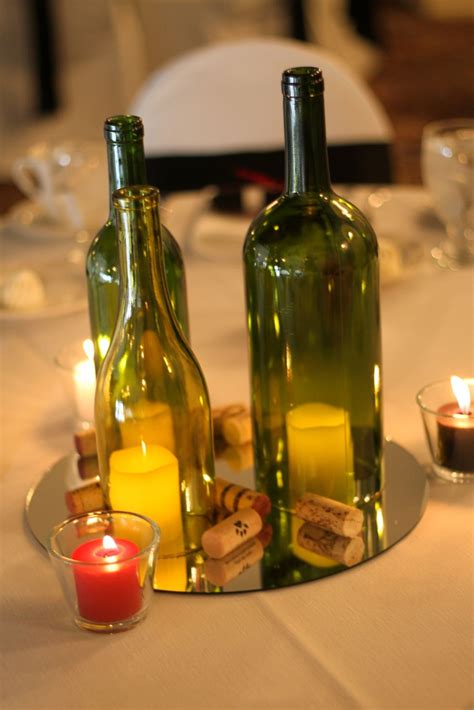Centerpiece 3 Wine Bottles W Flowers On Mirror W Corks Around Wine