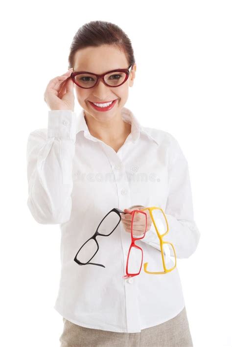Beautiful Woman In Eyeglasses Holding Three Different Pair Of