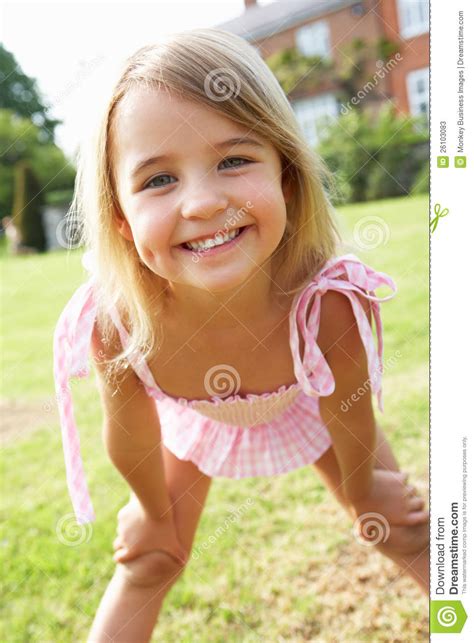 Portrait Of Young Girl Standing In Garden Stock Image
