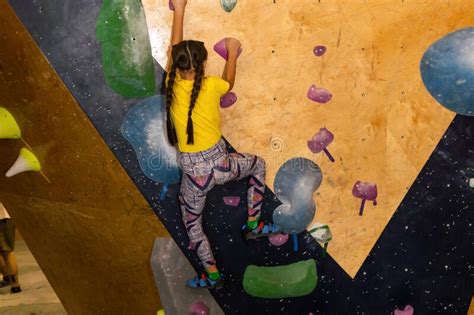 Instructors Helping Children Climb Wall In Gym Stock Photo Image Of