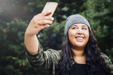 Mixed Race Woman Posing For Cell Phone Selfie In Forest Photo12 Tetra Images Inti St Clair