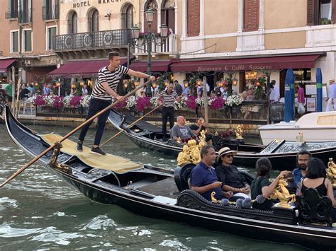 Tourists Enjoying Gondola Rides And Dinner In Venice Italy Venice