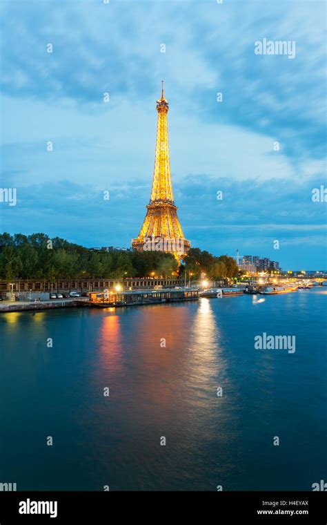 Beautiful Paris View Of Illuminated Eiffel Tower Along Seine River At
