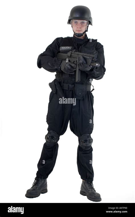 A Police Officer Dressed In A Swat Team Riot Uniform Holding And Stock