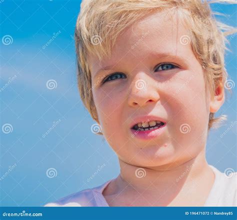 Close Up Boy Portrait Serious Male Child Squints A Little In Sunny