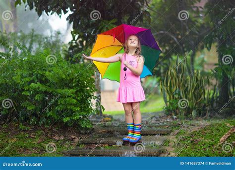 Kid With Umbrella Playing In Summer Rain Stock Photo Image Of Heavy