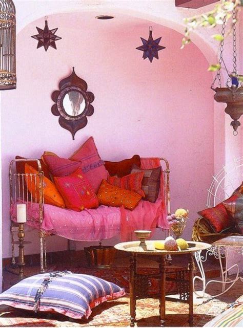 A Living Room Filled With Lots Of Furniture Next To A Pink Wall Covered