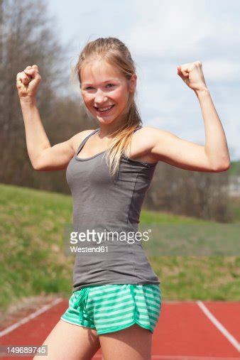 Austria Teenage Girl On Track Showing Her Muscles Smiling Portrait