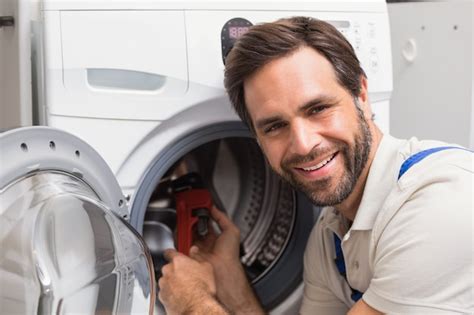 Premium Photo Handyman Fixing A Washing Machine