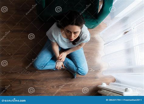 View From Above At Depressed Caucasian Young Woman Sitting Crossed Legs