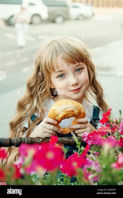 Lovely Blue Eyed Girl With A Pretzel On The Street Portrait Of A Blue