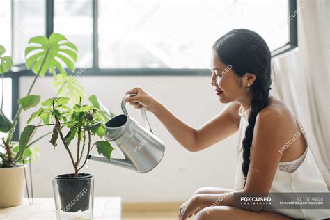 Young Woman At Home Watering Plant — Caring One Person Stock Photo