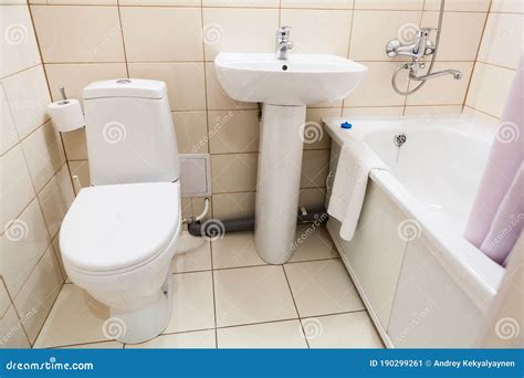 Simple Half Bathroom With Toilet Sink And Bath With Shower White