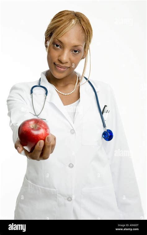 Attractive Young Female Doctor Wearing A White Coat Offers A Patient A