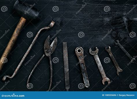 Old Rusty Tools Lying On A Black Wooden Table Hammer Chisel Metal