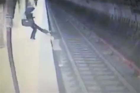 Woman Desperately Tries To Claw Her Way Back Onto Platform After Being Pushed In Front Of Train