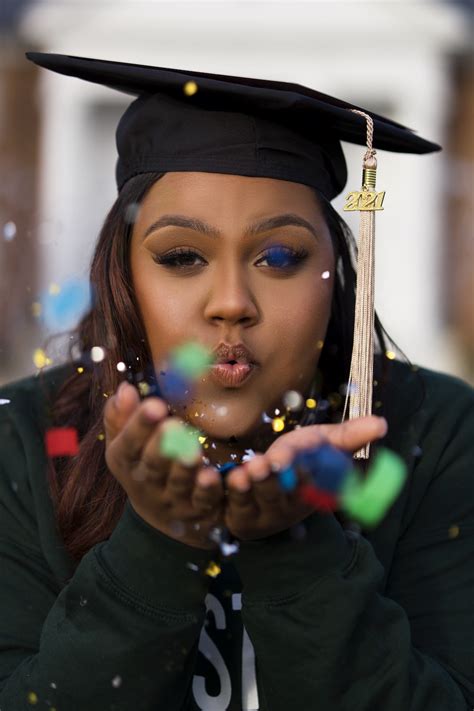 A Woman In A Graduation Cap Blowing Bubbles Photo Free Qualified