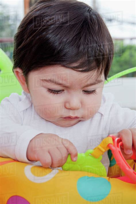 Hispanic Baby Boy Playing With Toy Stock Photo Dissolve