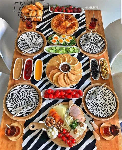A Wooden Table Topped With Lots Of Plates And Bowls Filled With