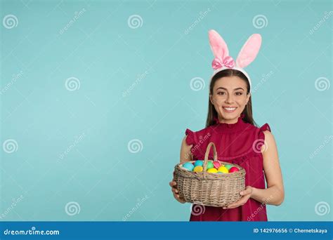 Beautiful Woman In Bunny Ears Headband Holding Basket With Easter Eggs