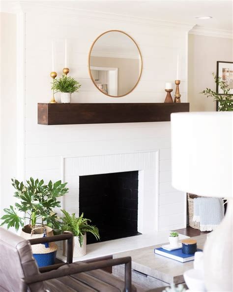 Unique wall mirror above fireplace ideas for gorgeous living. The white shiplap fireplace paired with the brass mirror ...