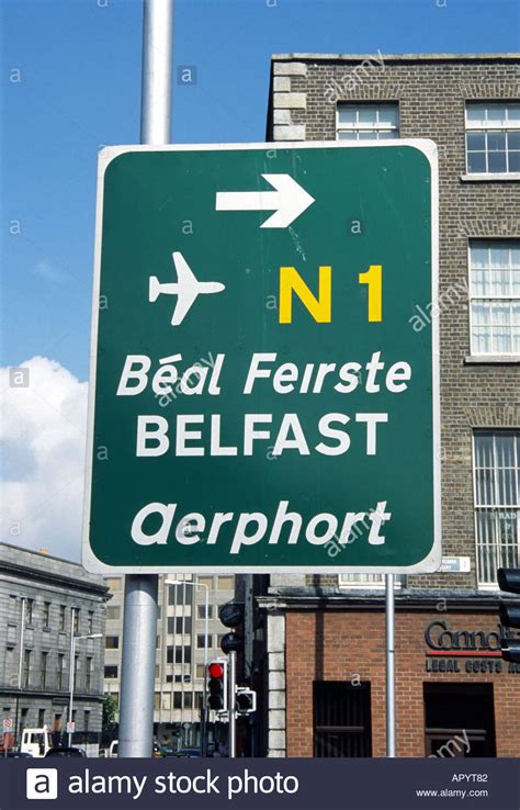 Dublin Ireland Sign To Belfast In English And Gaelic Stock Photo