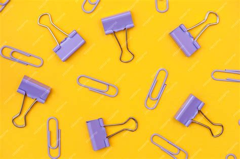 Premium Photo Collection Of Purple Paper Clips On A Yellow Background