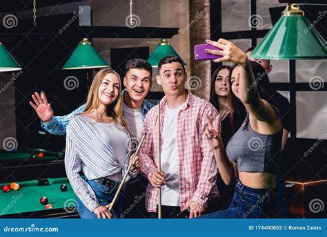 A Group Of Friends Makes A Selfie At The Pool Table Stock Image Image Of Billiard Club