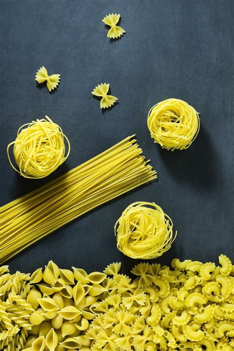Different Types Of Dried Italian Pasta On A Blue Background Top View
