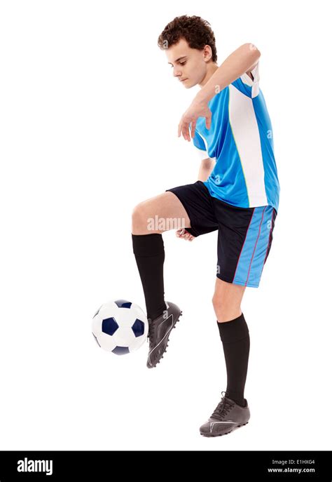 Teenager Boy Soccer Player Kicking The Ball Isolated On White