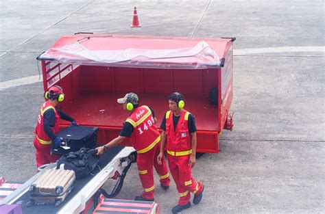 Air asia — lost luggage. Air Asia Low Cost Airline Porters Quickly Unloading ...