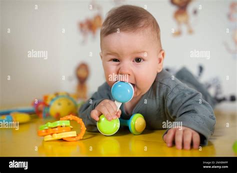 Cute Baby Boy Nibbles And Eats Colourful Toys Because Her Small New