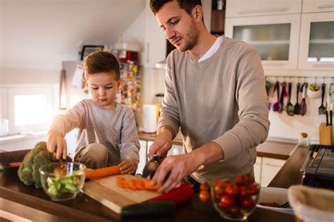Father And Son Preparing Healthy Food In The Kitchen 650407076