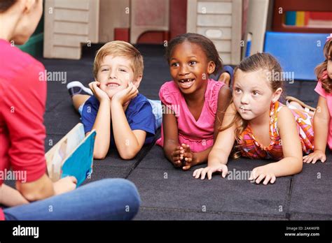 Children Laughing While Reading Story Hi Res Stock Photography And