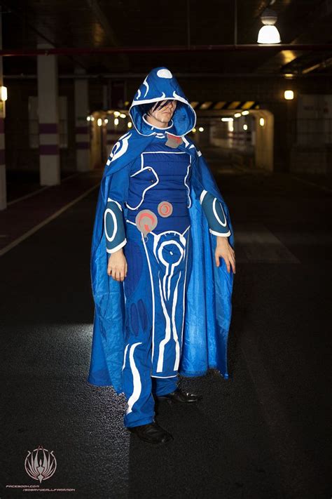 A Man In A Blue Costume Standing On The Street