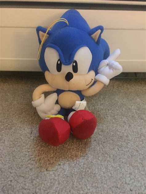 A Sonic Doll Sitting On The Floor Next To A Radiator