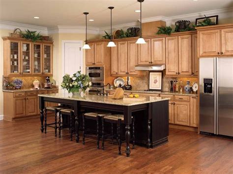 It will affect the other choices you make, such as the cabinets and flooring or wall color. honey-colored-oak-cabinets-with-dark-wood-floor-and-black-island-design | Kitchen renovation ...