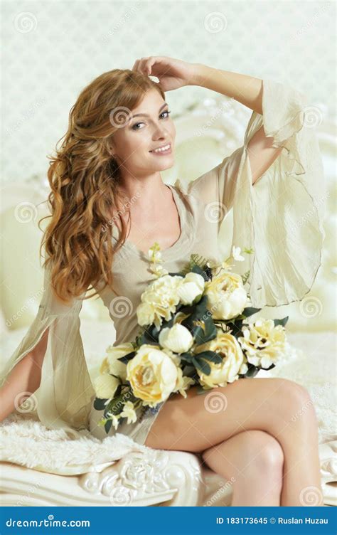 Beautiful Young Woman Posing With Flowers At Home Stock Image Image