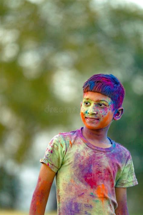 Indian Child Playing With The Color In Holi Festival Stock Photo