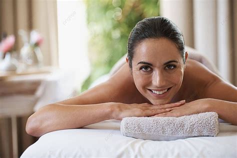 Indulge In A Relaxing Massage Captivating Image Of A Woman Reclining On A Massage Table Photo