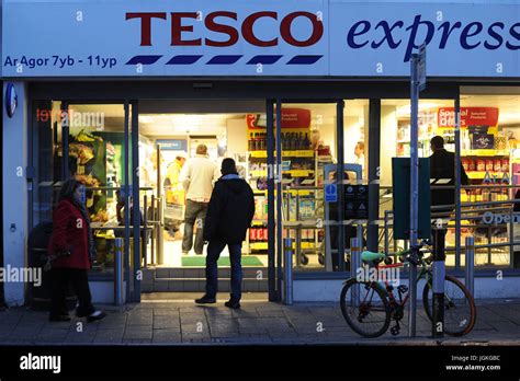 General View Of A Tesco Express Supermarket Store During The Evening