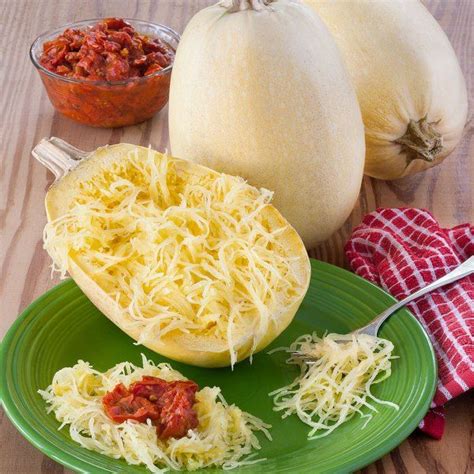 Spaghetti On A Green Plate Next To Two Squash