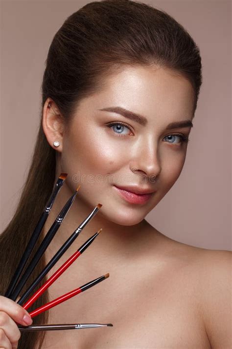 Beautiful Young Girl With Natural Nude Make Up With Cosmetic Tools In