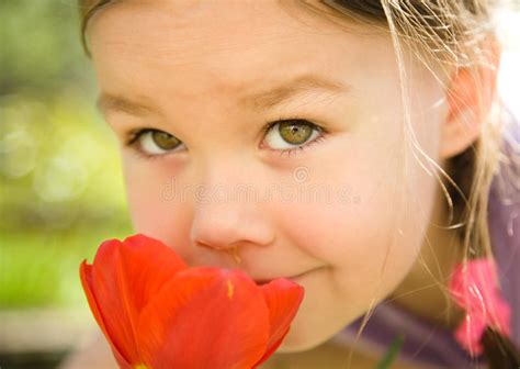 Portrait Of A Cute Little Girl Smelling Flowers Stock Image Image Of