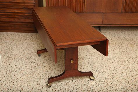 Well you're in luck, because here they come. Exceptional Walnut Convertible Coffee Dining Table at 1stdibs