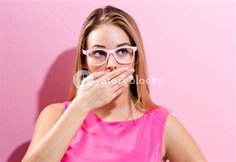 Young Woman Covering Her Mouth On A Pink Background Royalty Free Stock Image Storyblocks