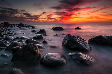 Rocks On A Beach At Sunset By The Sea Photograph By Andreas Jakel