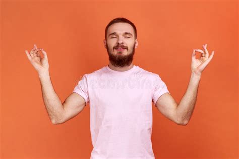 Man Standing With Raised Arms And Doing Yoga Meditating Exercise Mudra
