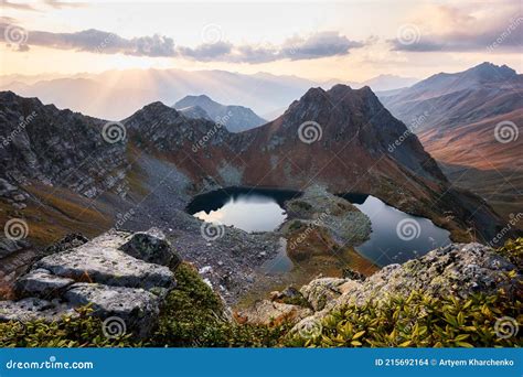 Beautiful Mountains At Sunset In Clouds Gold Alpine Field Lakes And